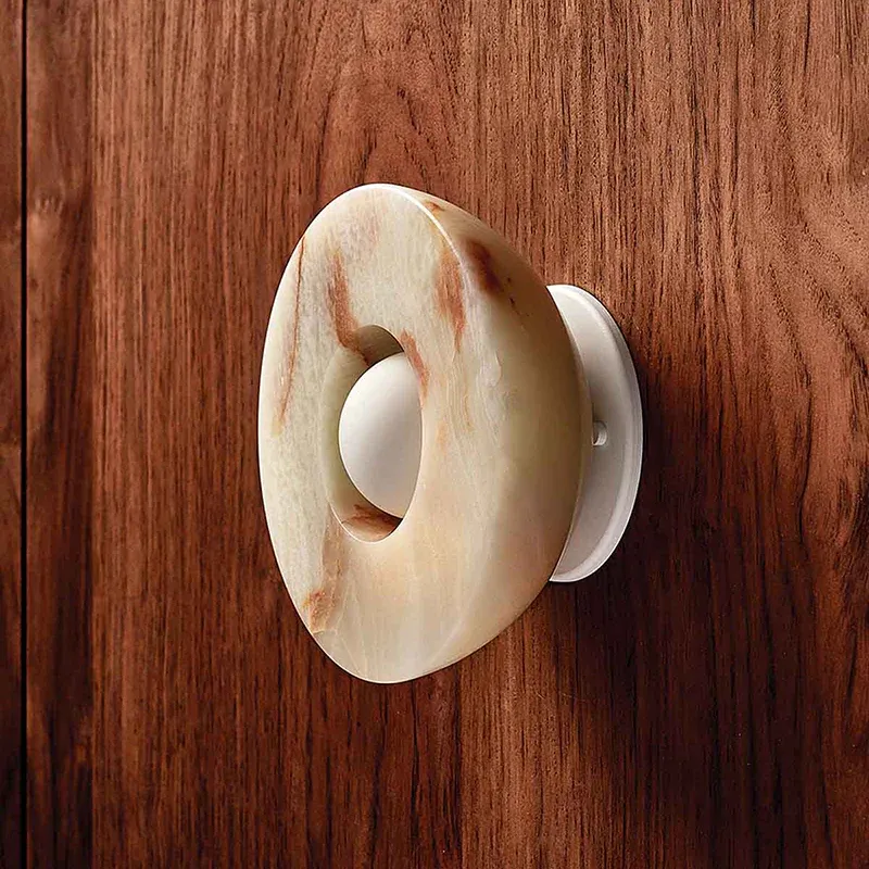 Elif Marble Wall Lamp close-up on wood, Lassola lighting