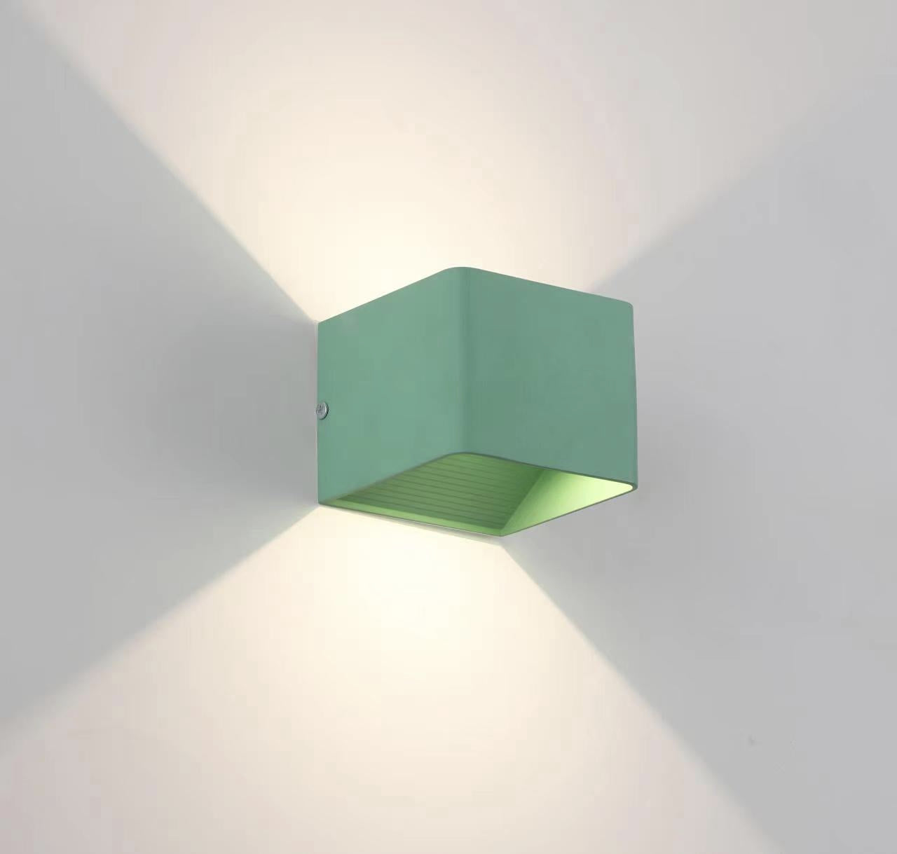 Green Orr Wall Lamp Square emitting warm light