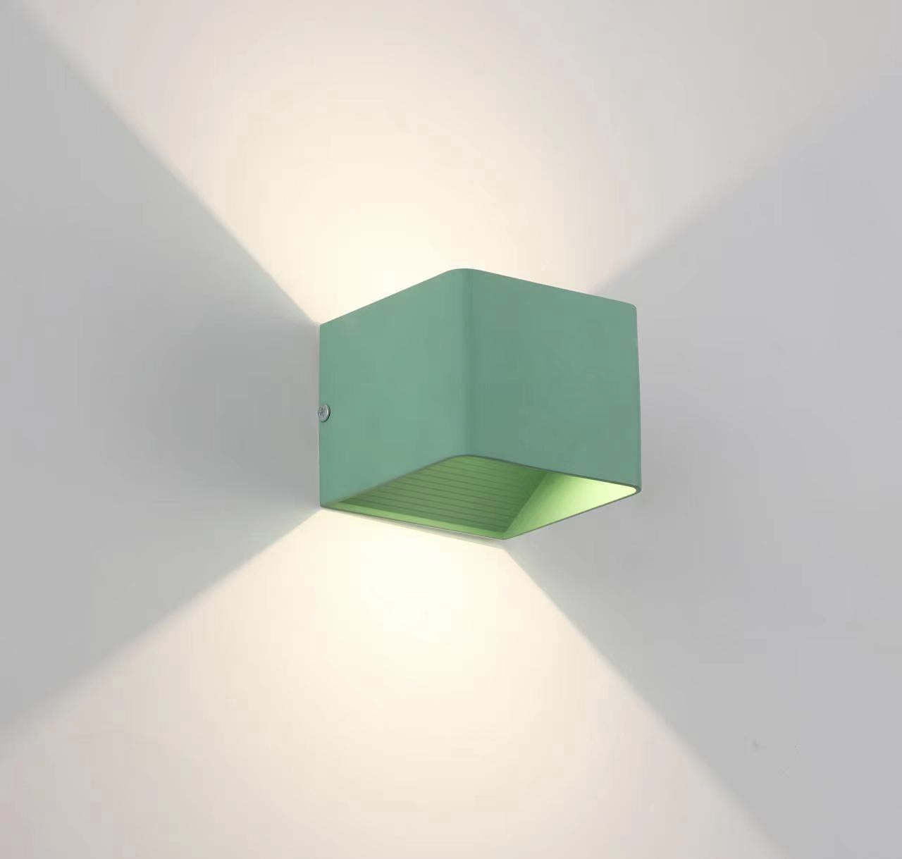 Green Orr Wall Lamp Square emitting warm light