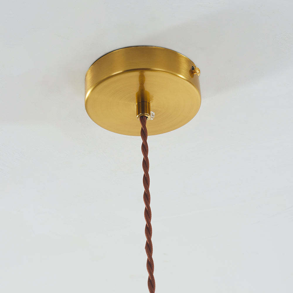 Brass ceiling canopy and brown twisted cord of Hailie pendant light.