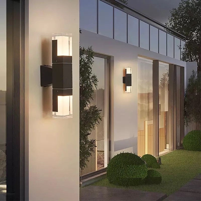 Modern outdoor wall lamp illuminating a contemporary home exterior