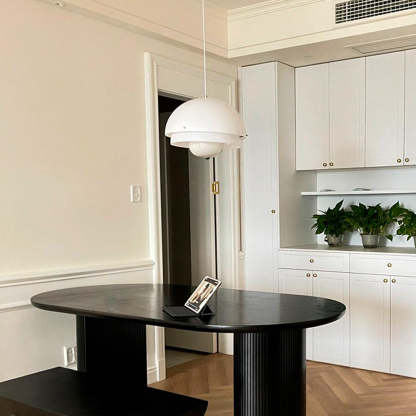 Hailie pendant light above a modern dining table.