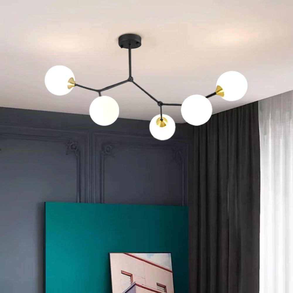 Modern branch chandelier with glass globes in bedroom setting