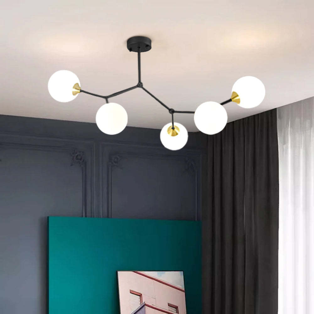 Modern branch chandelier with glass globes in bedroom setting