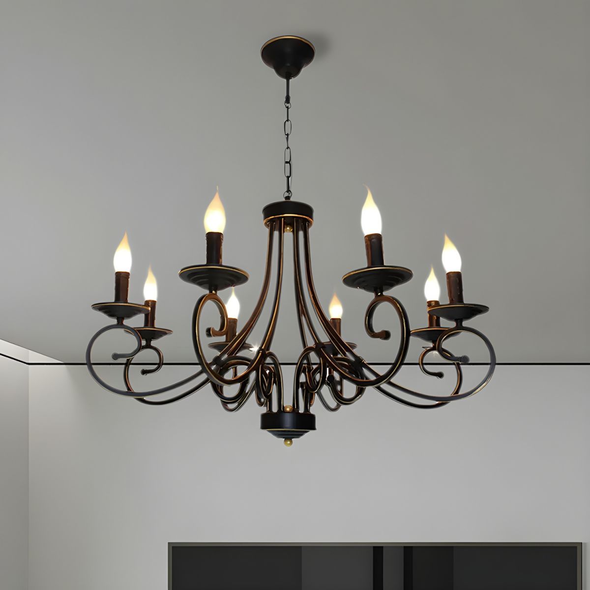 Black metal candle chandelier hanging from ceiling