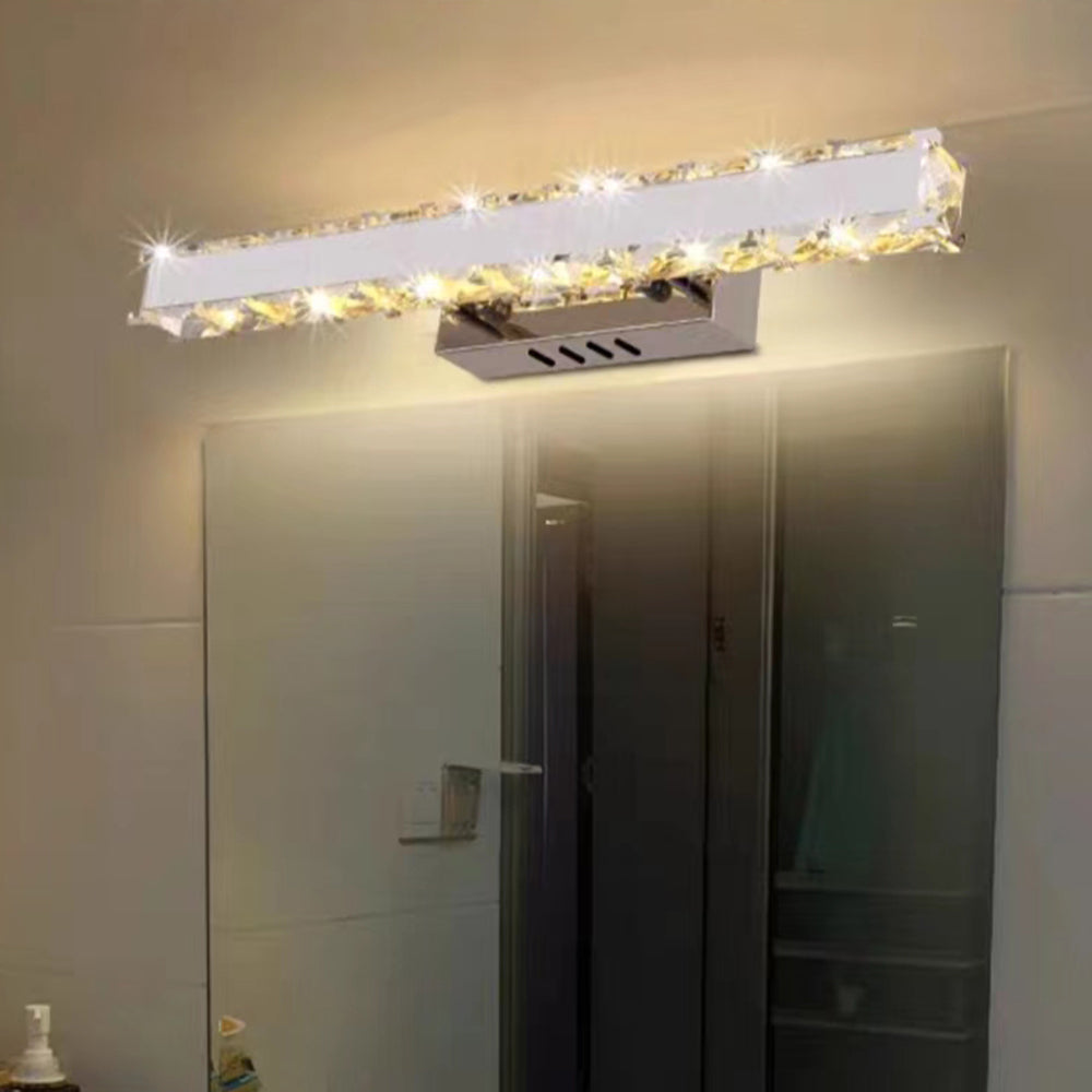 Modern crystal wall lamp above mirror