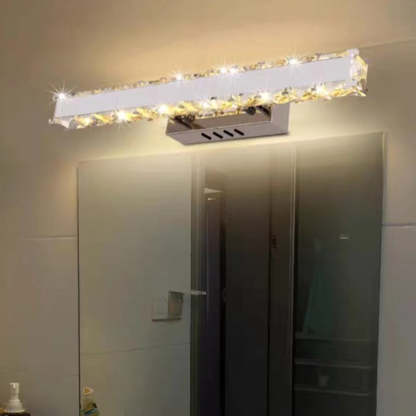 Modern crystal wall lamp above mirror