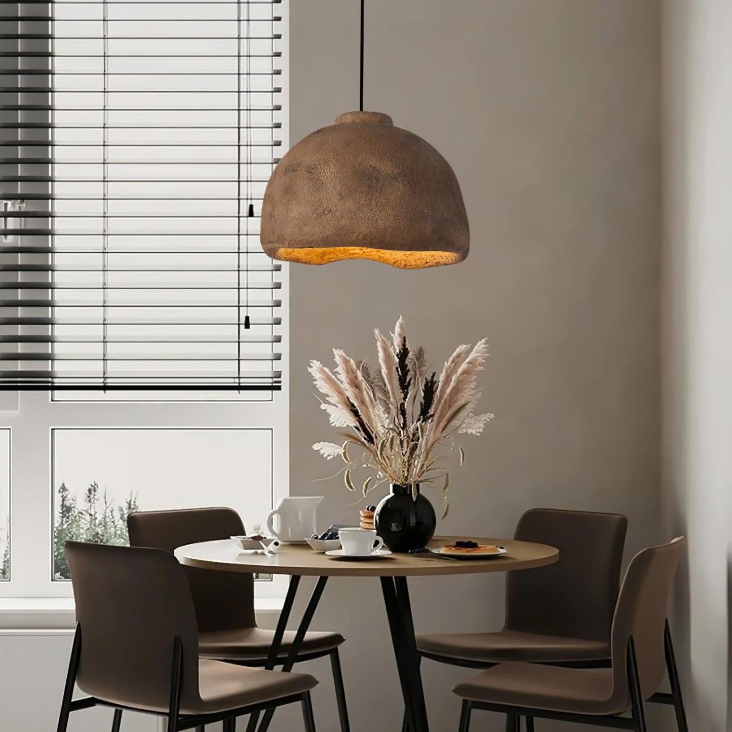 Cairns brown pendant light over dining table.