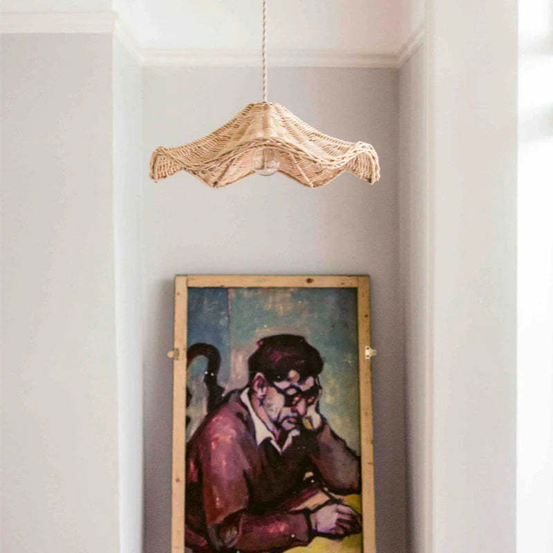 Ritta rattan pendant light above a painting in living room setting