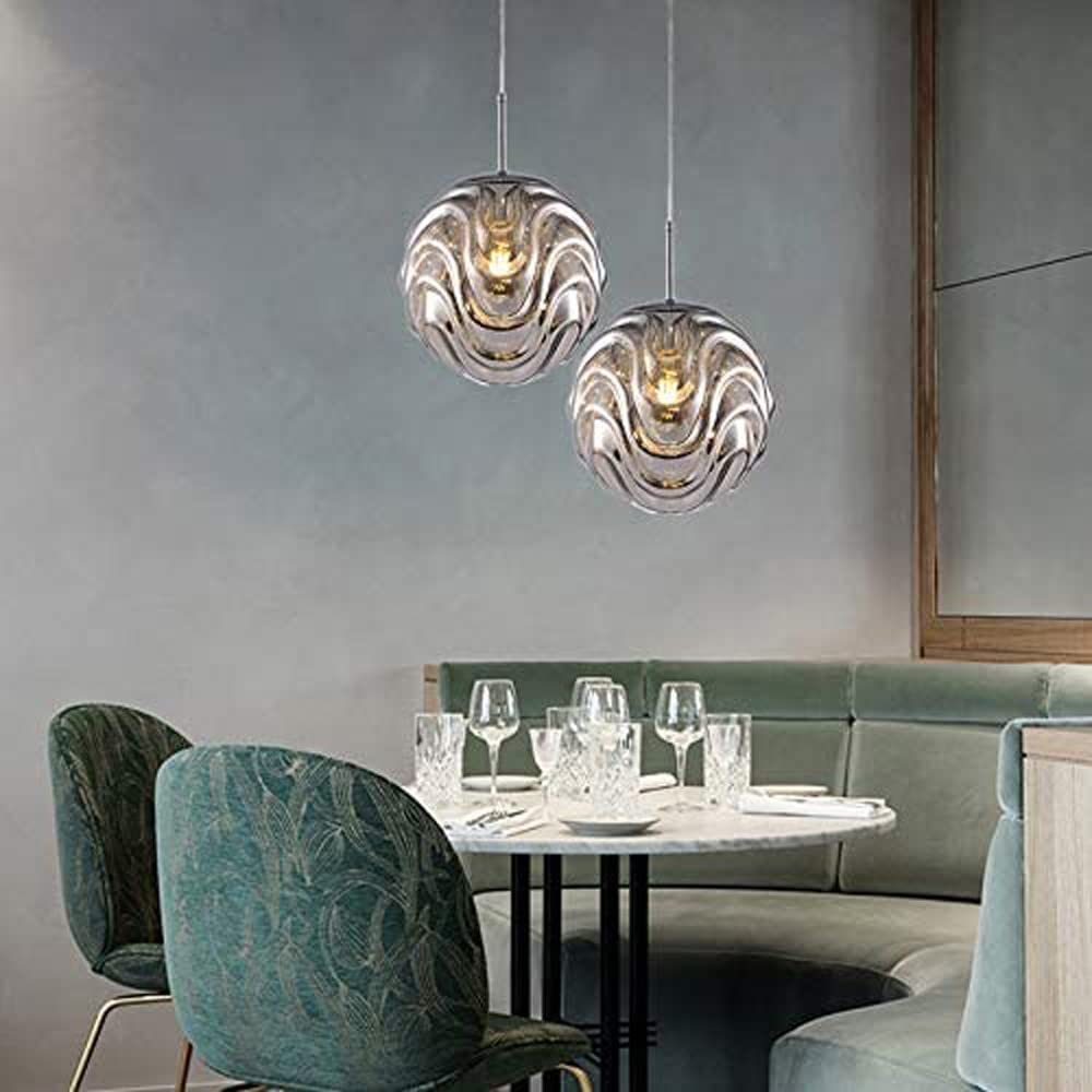 Modern sphere pendant lights above dining table