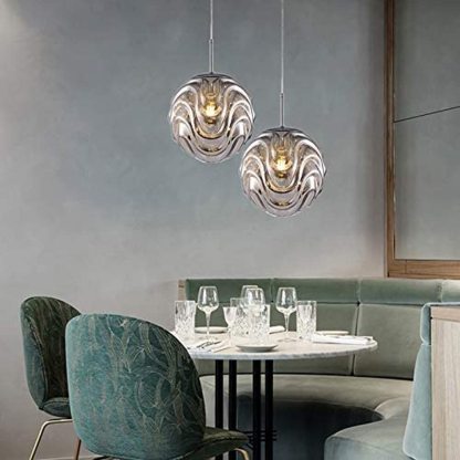 Modern sphere pendant lights above dining table