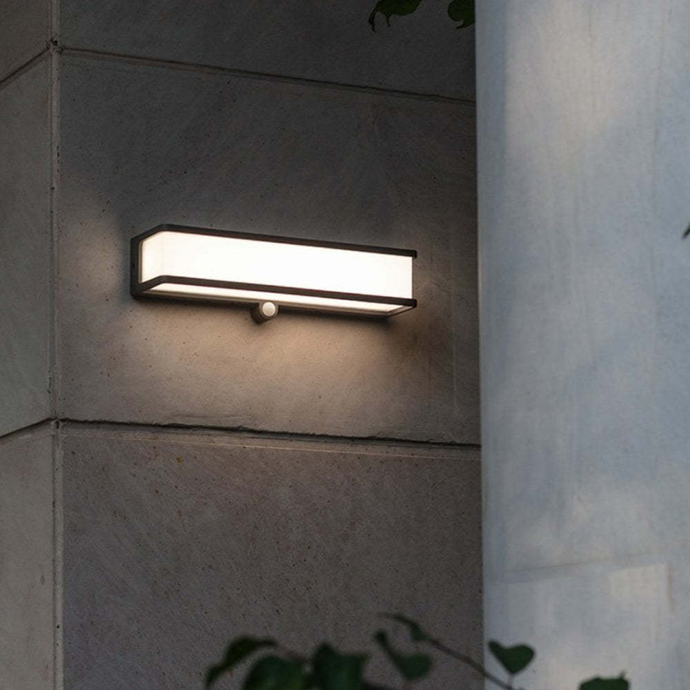 Orr solar wall lamp on concrete wall. Modern outdoor lighting.