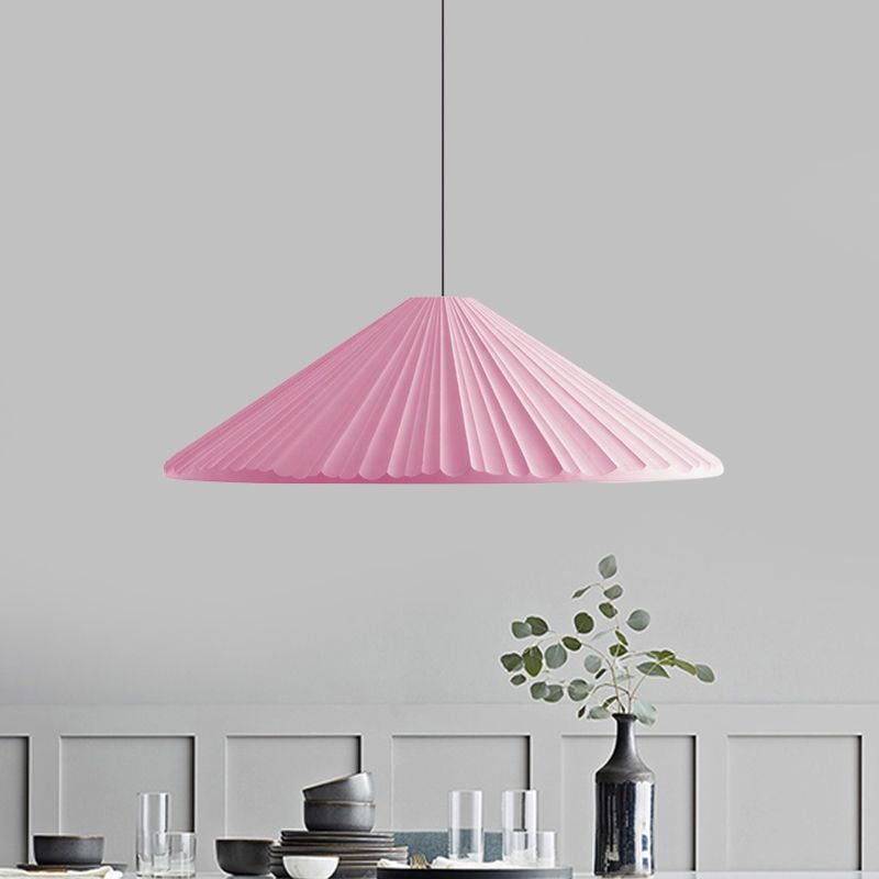 Las Sola pink pendant light over dining table.