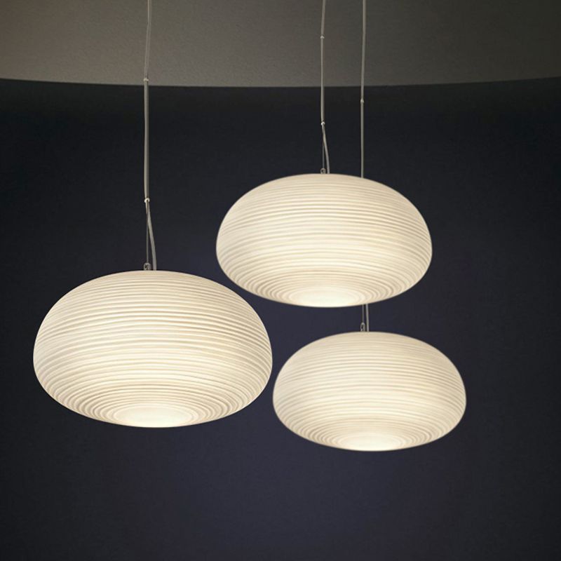 Three pebble-shaped white pendant lights