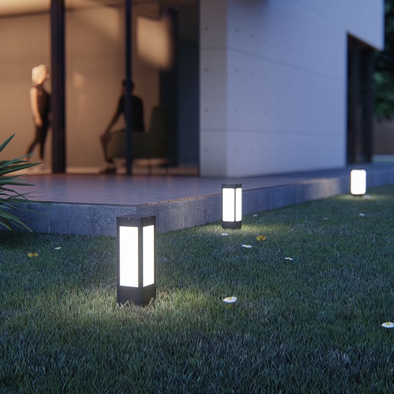 Modern outdoor path lights illuminating a garden at night