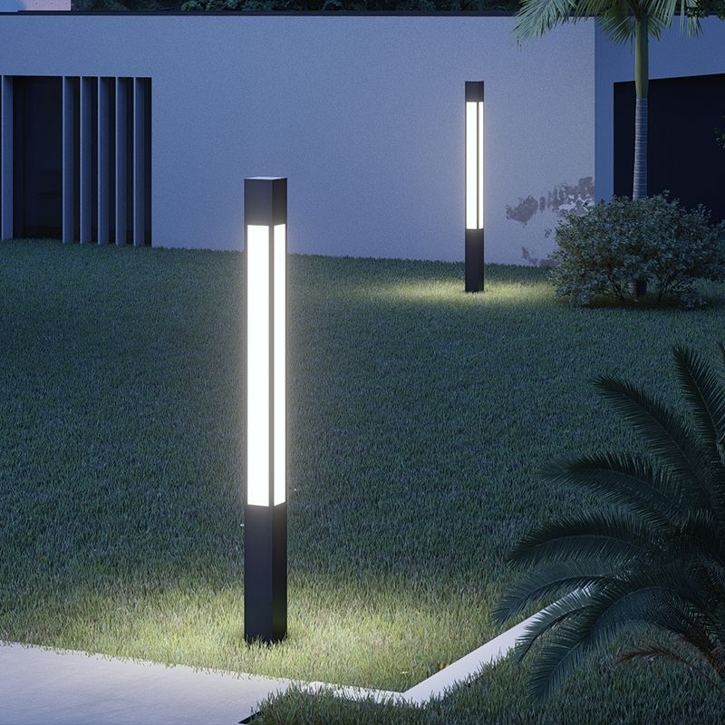Pena Modern Outdoor Path Lights illuminating a lawn