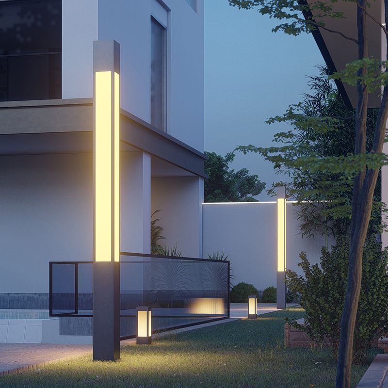 Outdoor path lights illuminating modern home garden at night
