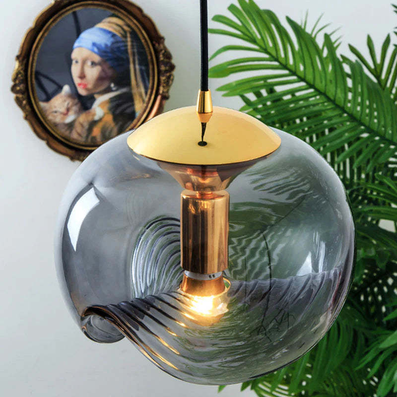 Modern glass pendant light, gold accents, interior design