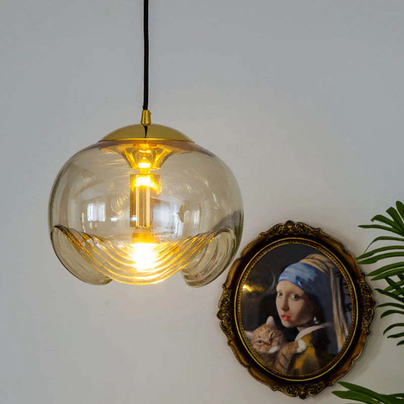 Amber glass pendant light with gold accents, classic decor