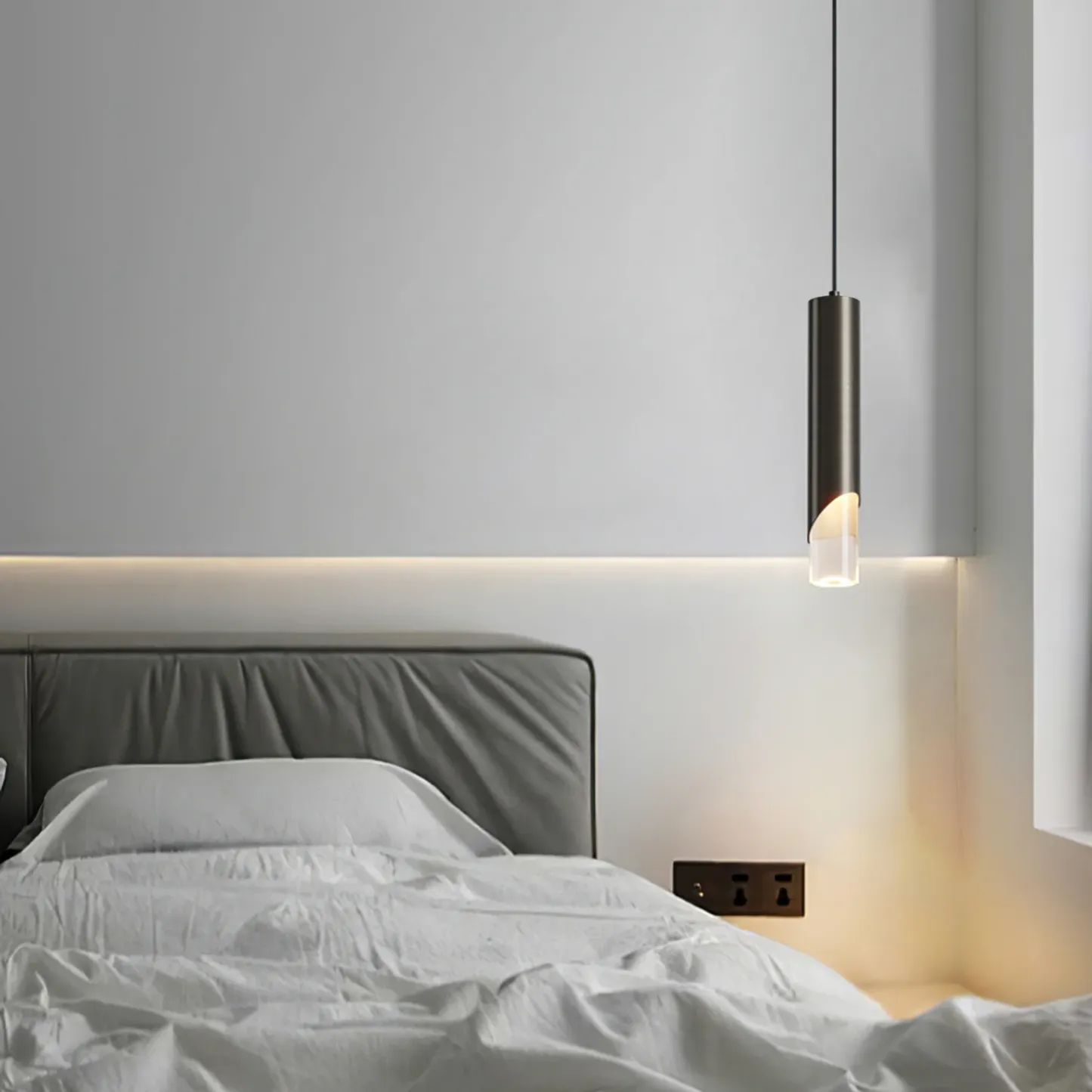 Modern cylinder pendant light in a bedroom setting