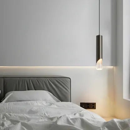 Modern cylinder pendant light in a bedroom setting
