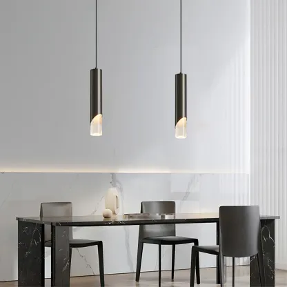 Modern cylinder pendant lights over dining table