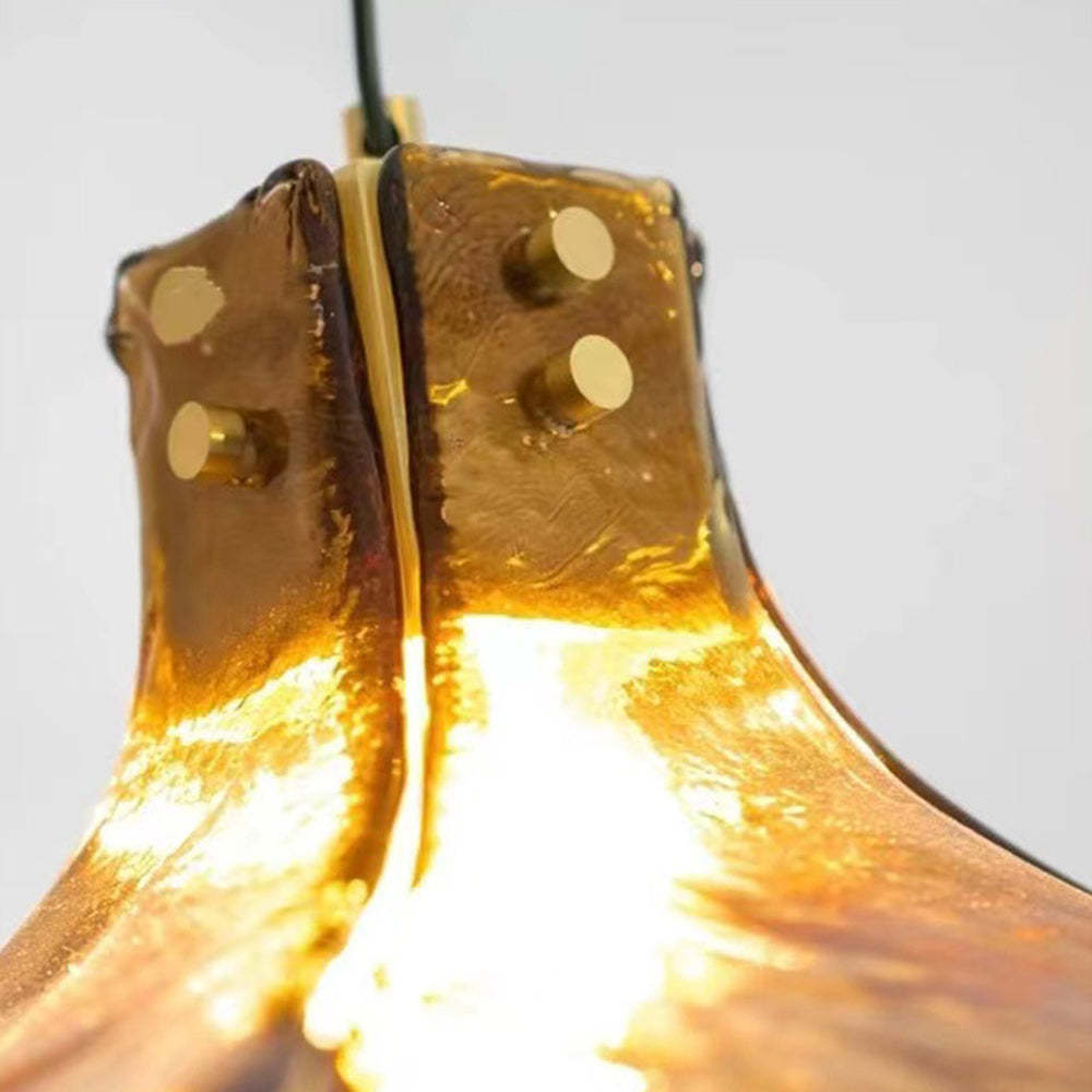 Carins retro pendant light. Amber glass four-leaf design.