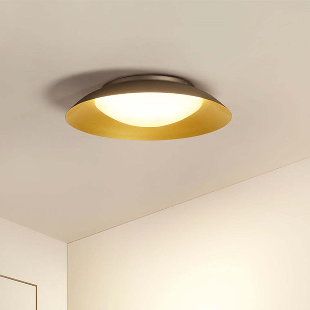 Carins flush mount ceiling light shining in room corner.