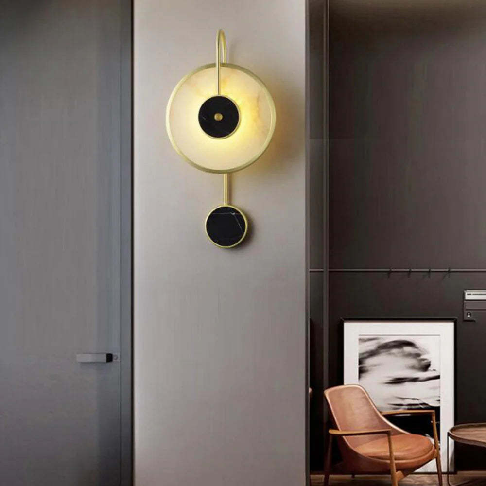 Modern Kristy wall lamp in bedroom setting, metal and marble