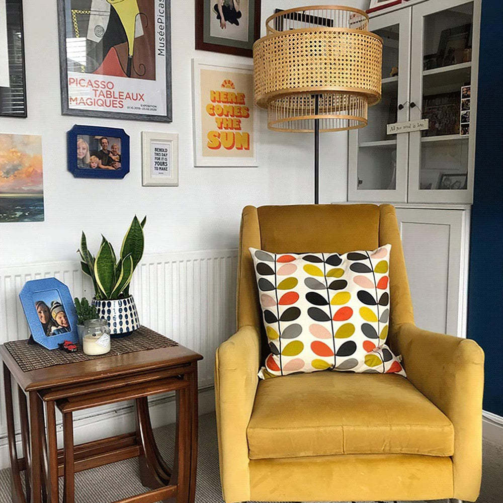 Ritta rattan floor lamp in living room with yellow chair.