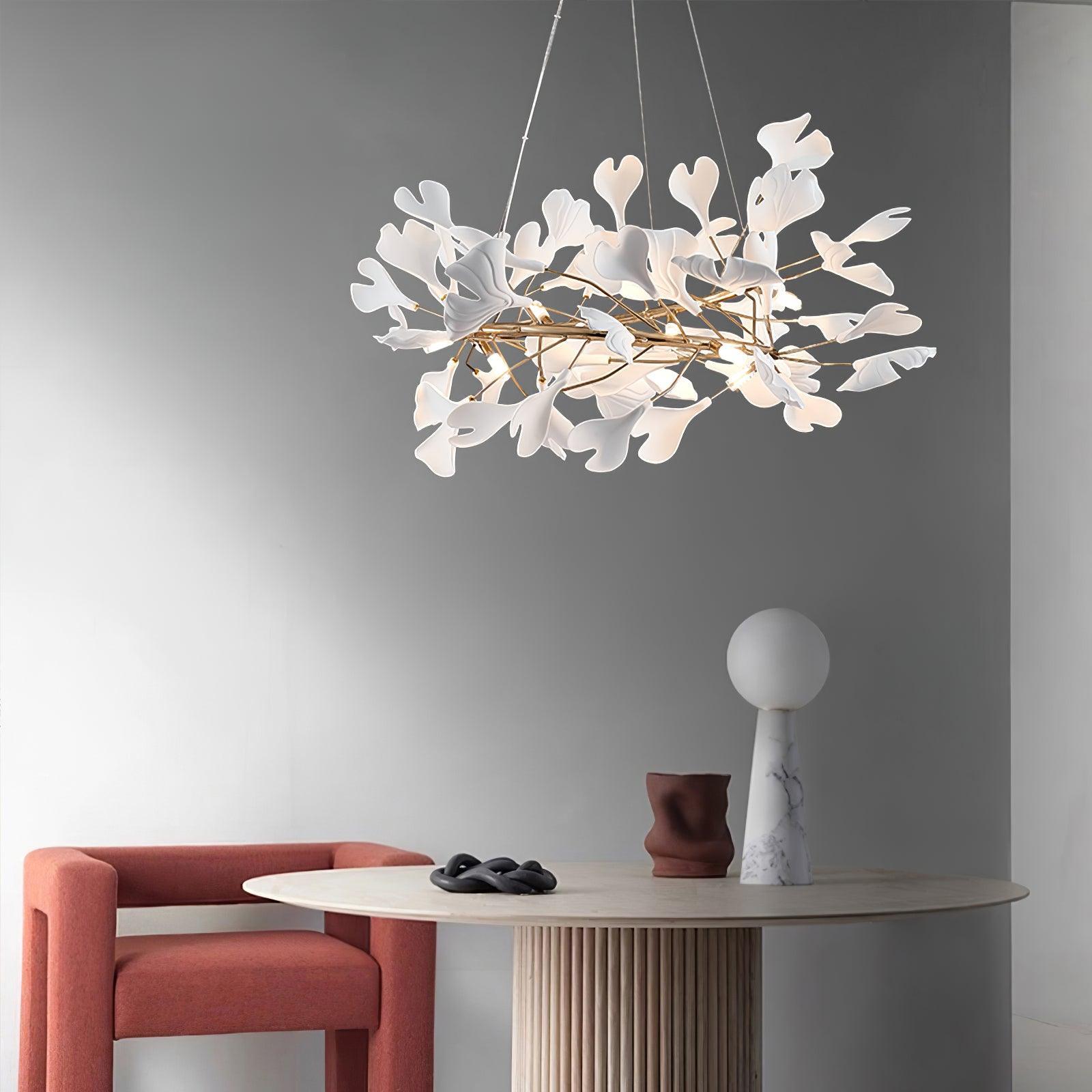 Modern chandelier over dining table setting with decorative objects