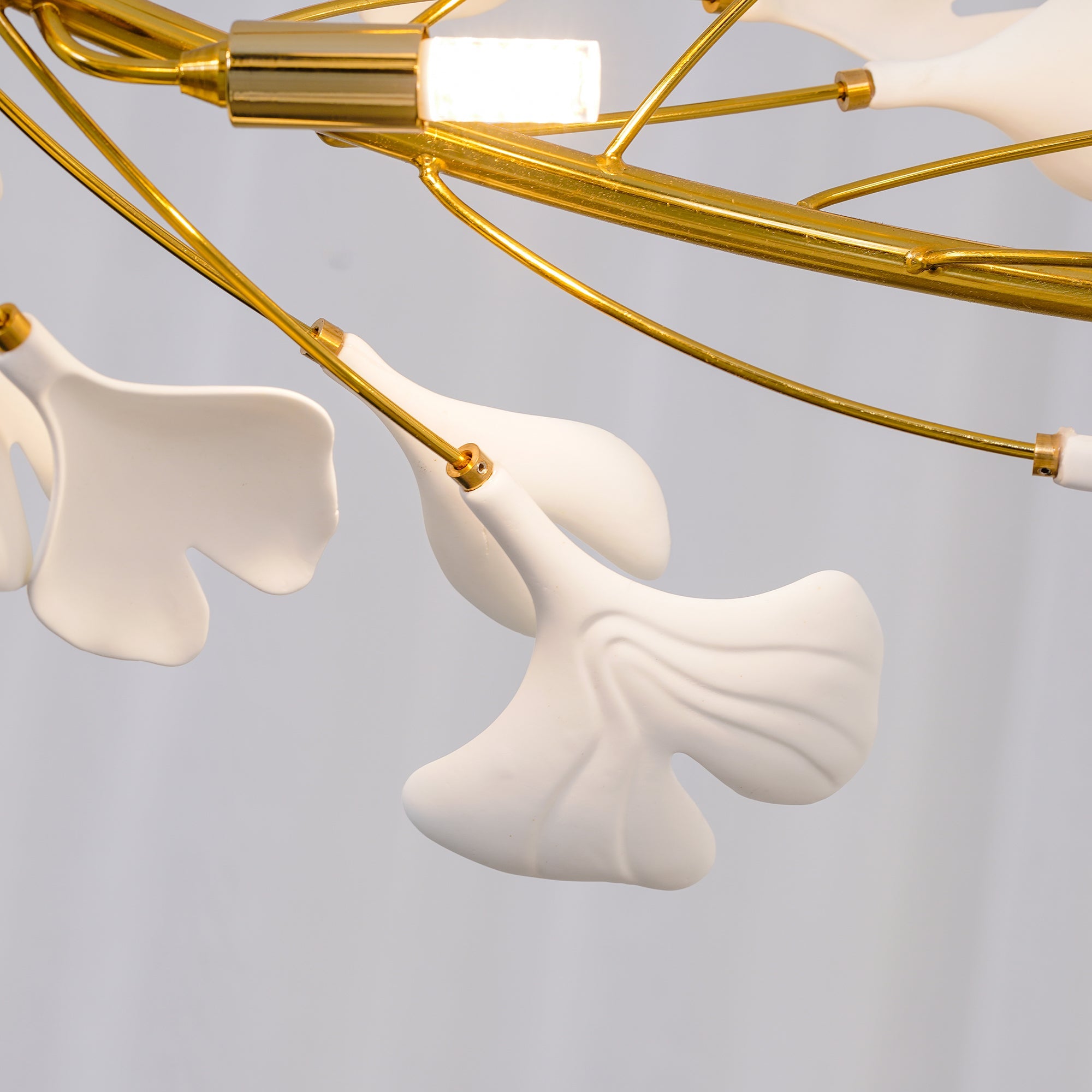 Close-up Olivia GinkLuxe Chandelier, metal and ceramic leaves