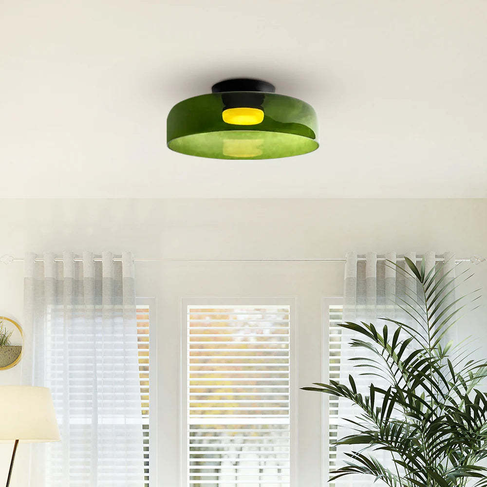 Green glass flush mount ceiling light in a bright room