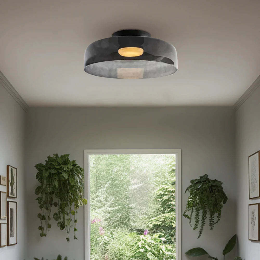 Modern flush mount ceiling light in room with natural light