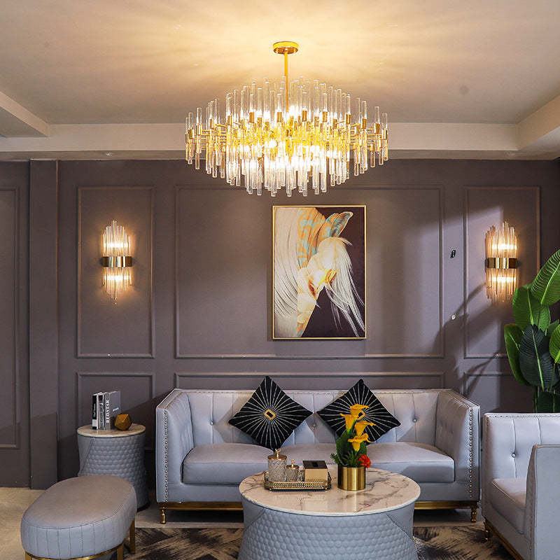 Luxurious living room with chandelier and wall lights.