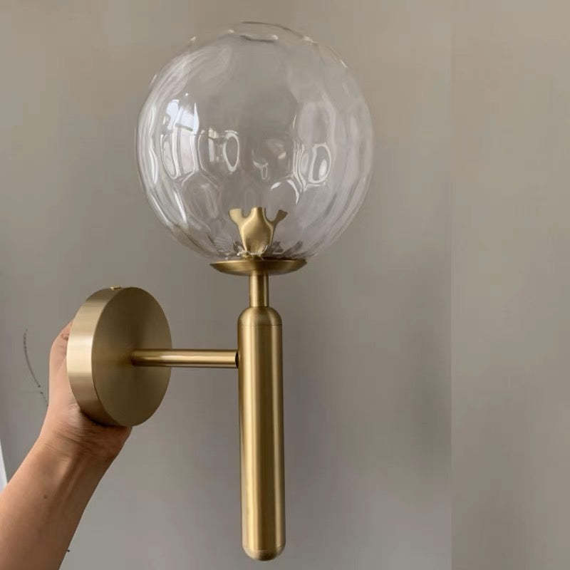 Valentina wall lamp with textured glass globe, gold finish