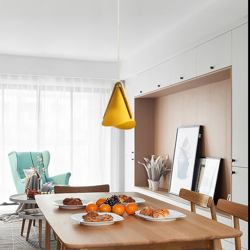 Yellow Morandi pendant light above dining table. Modern lighting.