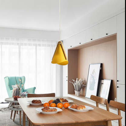 Yellow Morandi pendant light above dining table. Modern lighting.