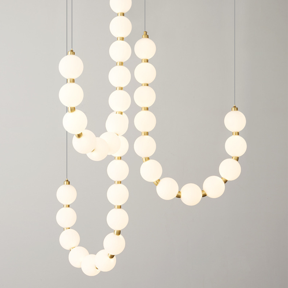 Valentina chandelier with white globe lights and brass accents
