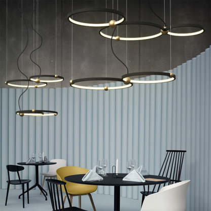 Arisha ring pendant lights in a modern dining room setup.