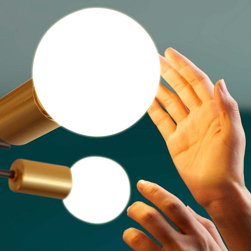 Hand reaching for a Valentina ceiling light bulb