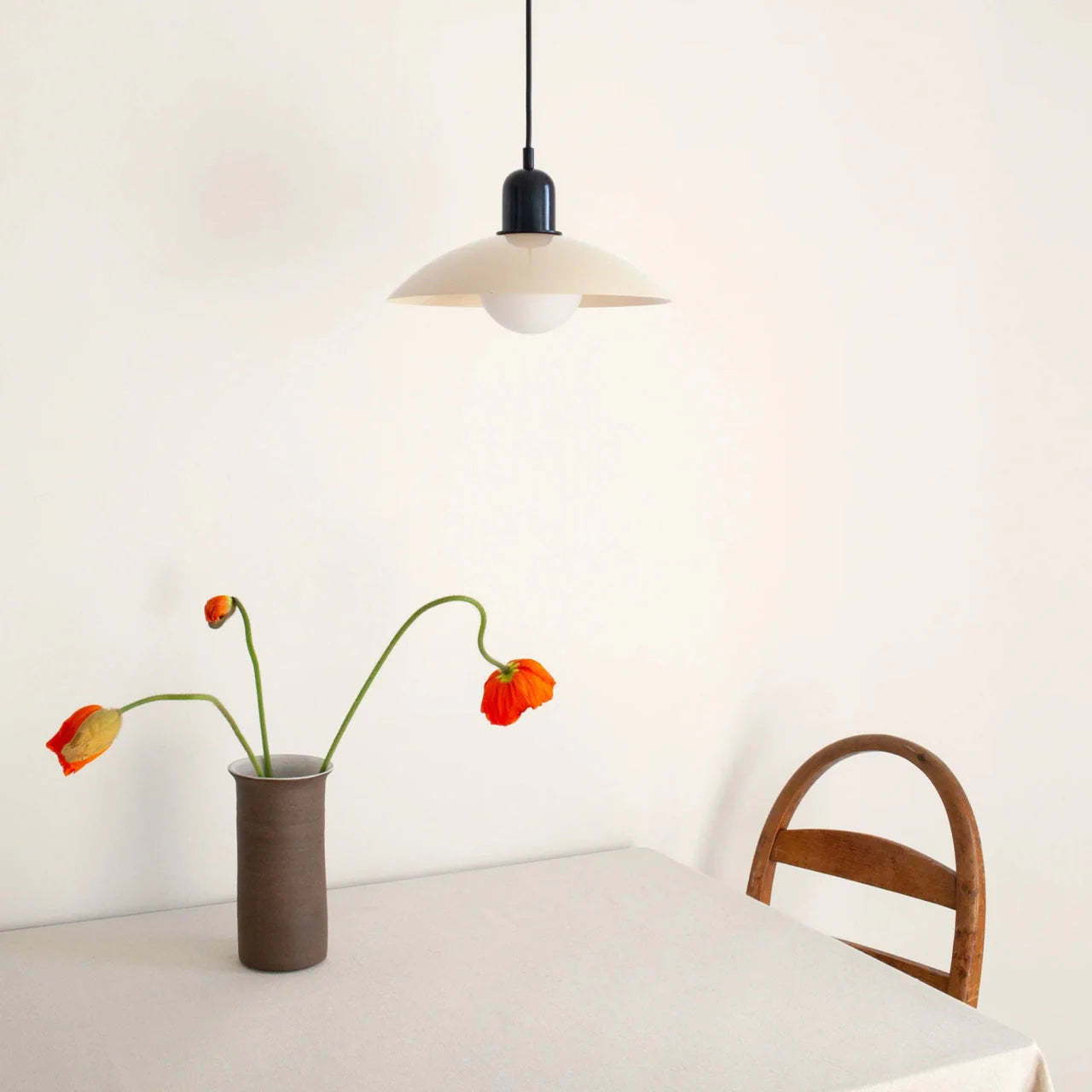 Morandi pendant light above table with flowers