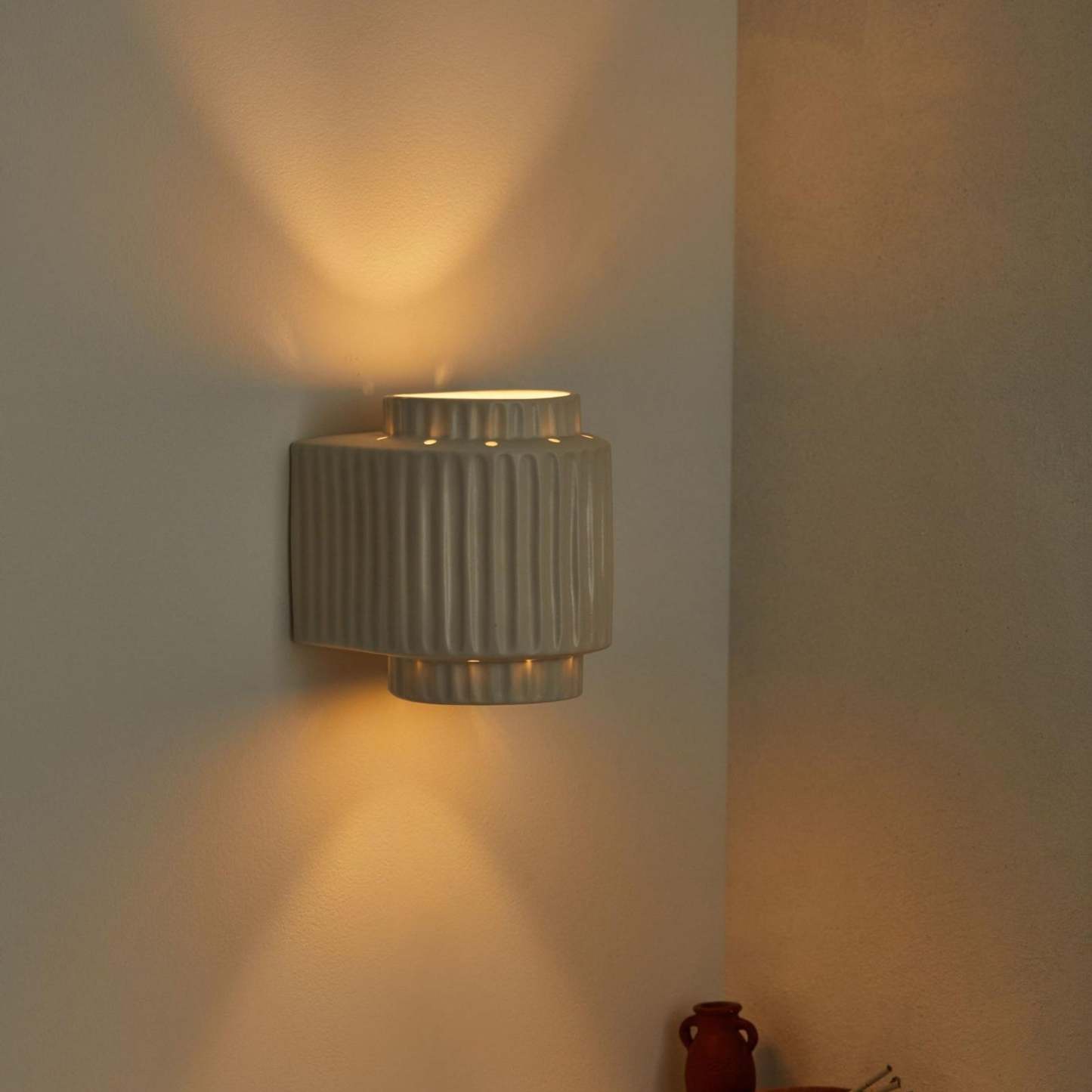 Vintage Cylindrique Resin Wall Lamp illuminating a bedroom