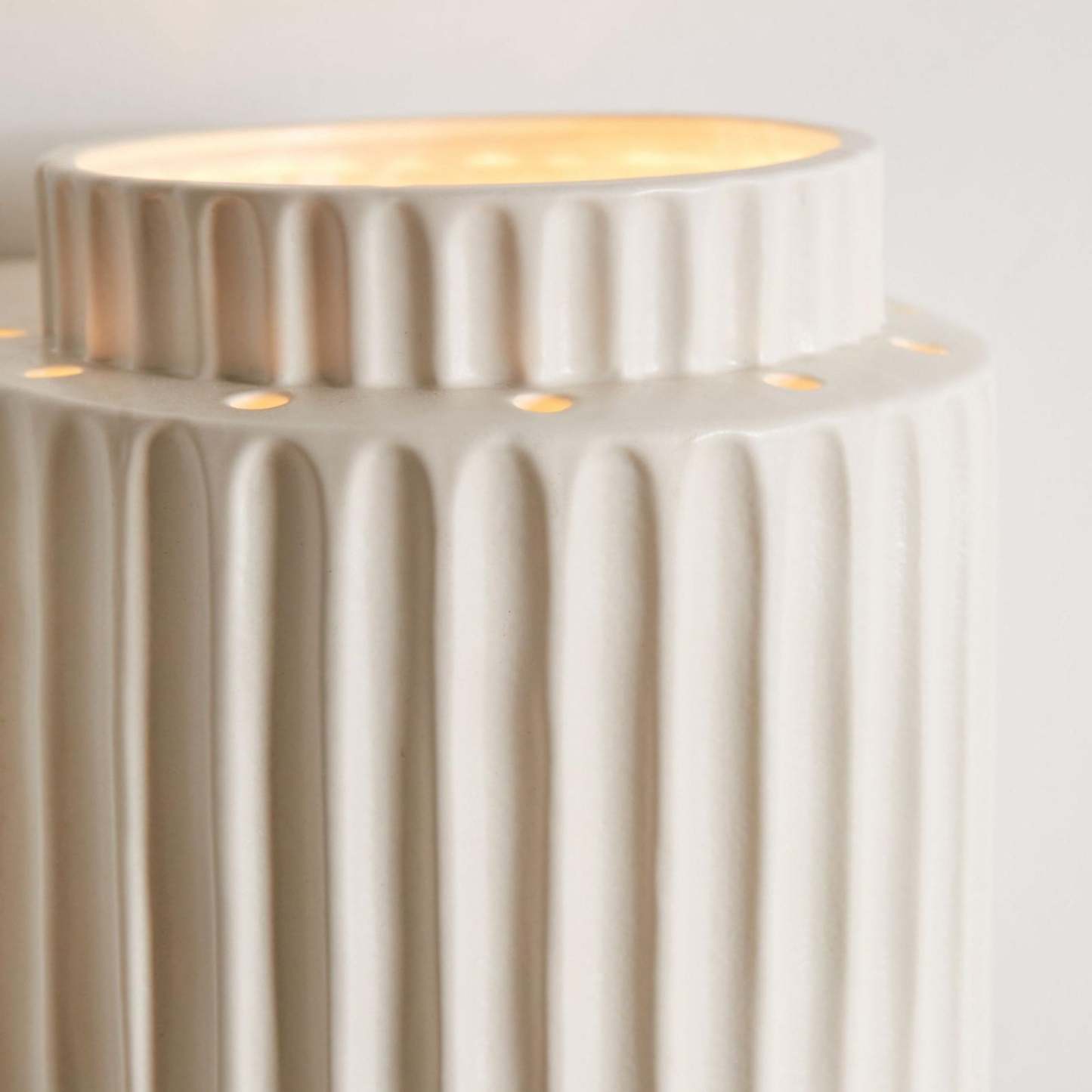 Close-up of white resin Cylindrique wall lamp detail, bedroom lighting