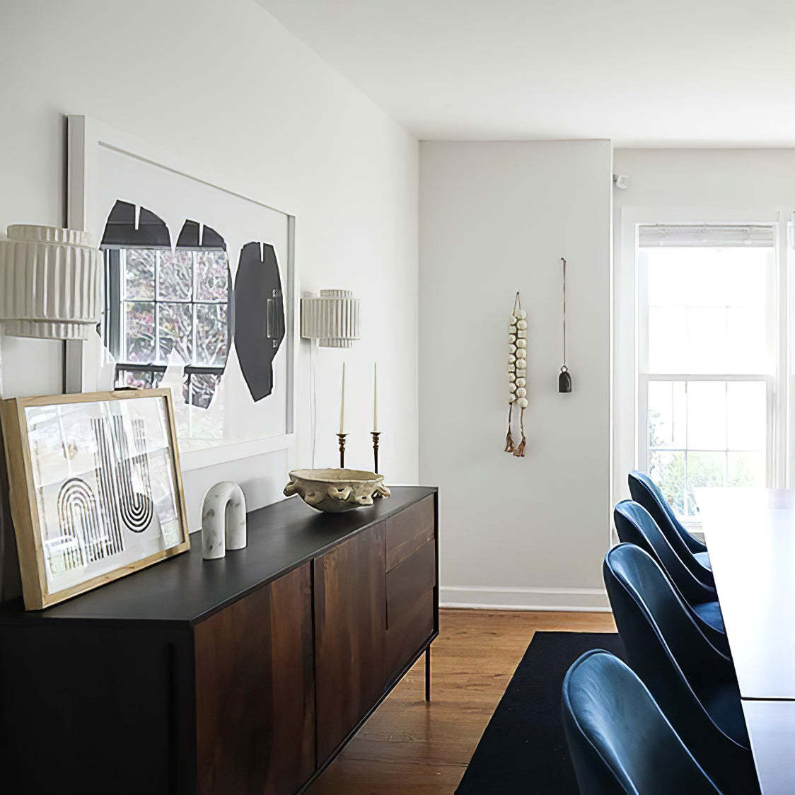 Bedroom interior design with modern wall lamp, decor and artwork