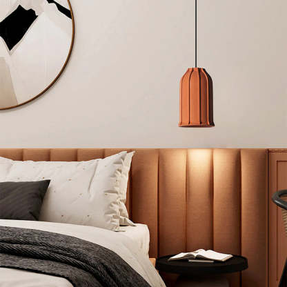 Modern pendant light above a bed