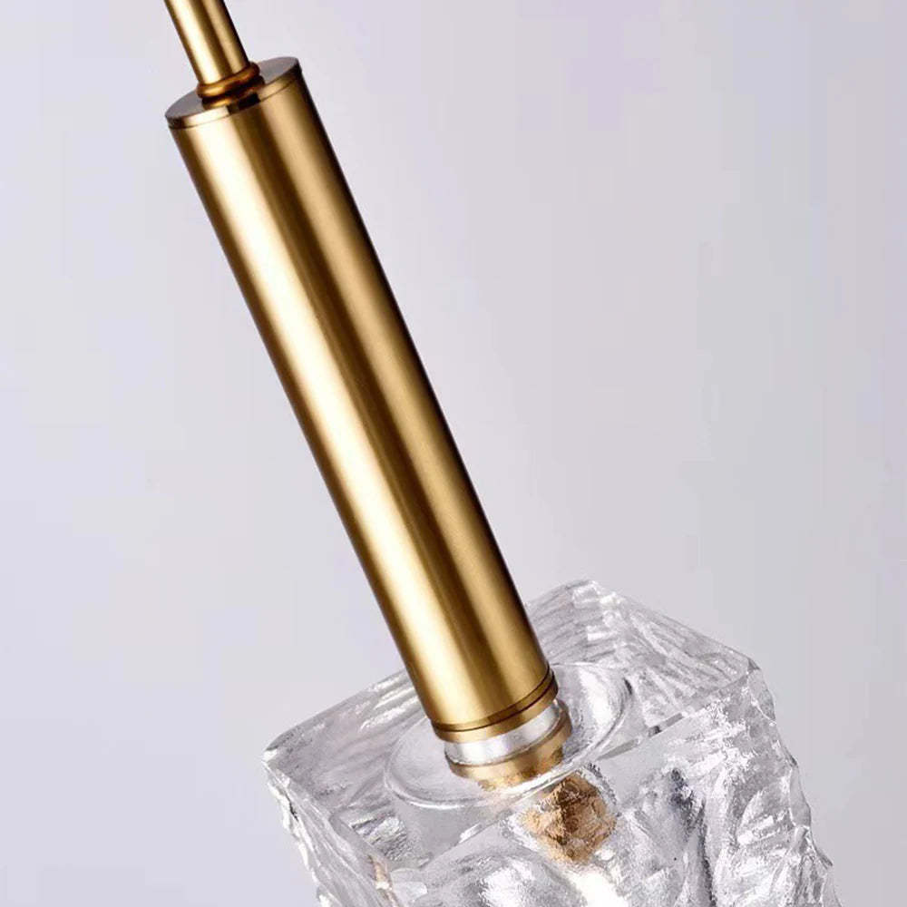 Close-up of Kristy pendant light: cube crystal shade and brass stem