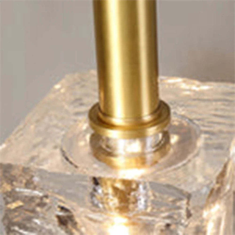 Close-up of Kristy pendant light detail: crystal shade and brass stem