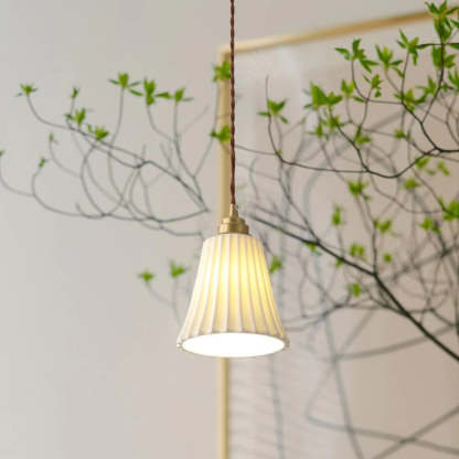 Alessio ceramic pendant light with plant.