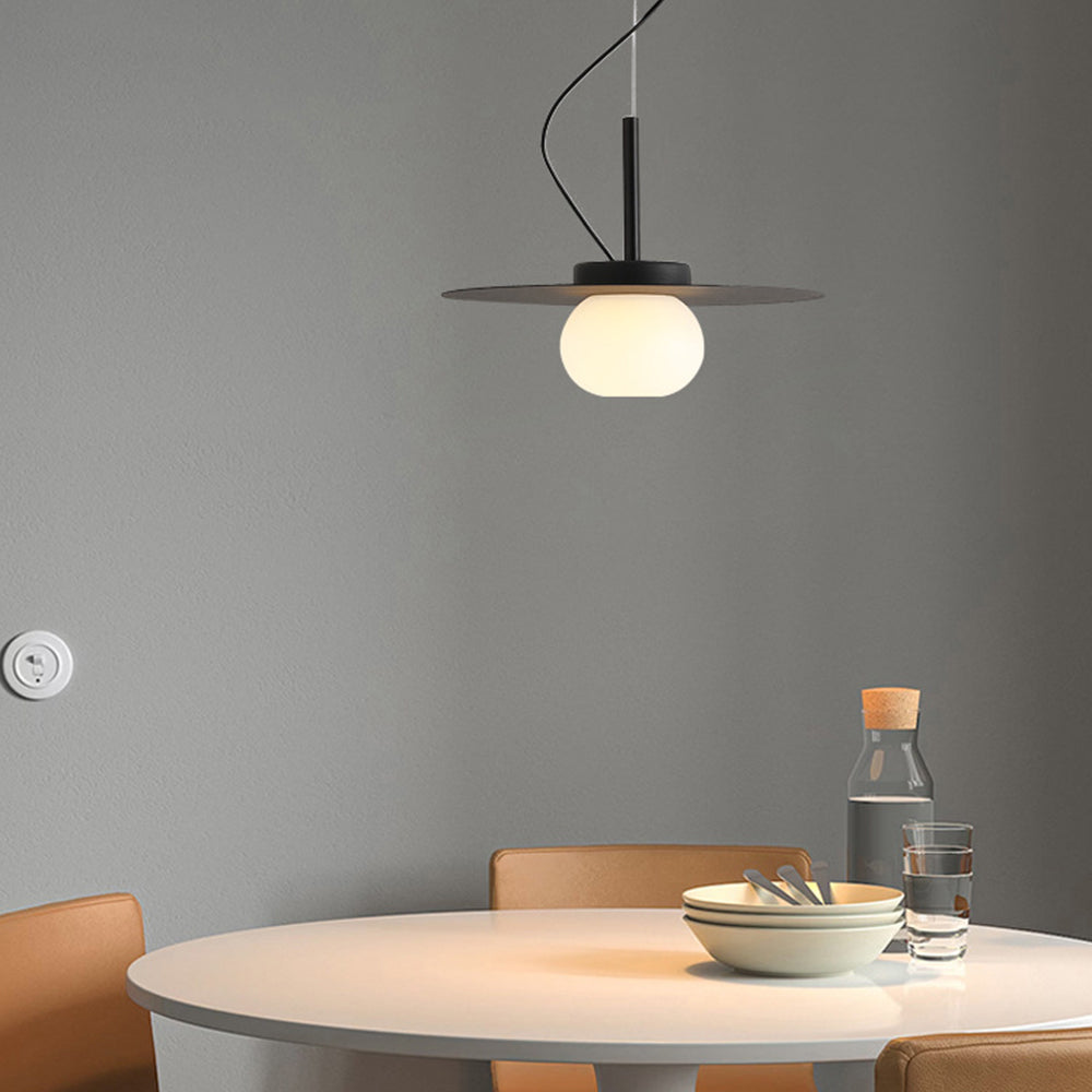 Minimalist pendant light over a dining table setting